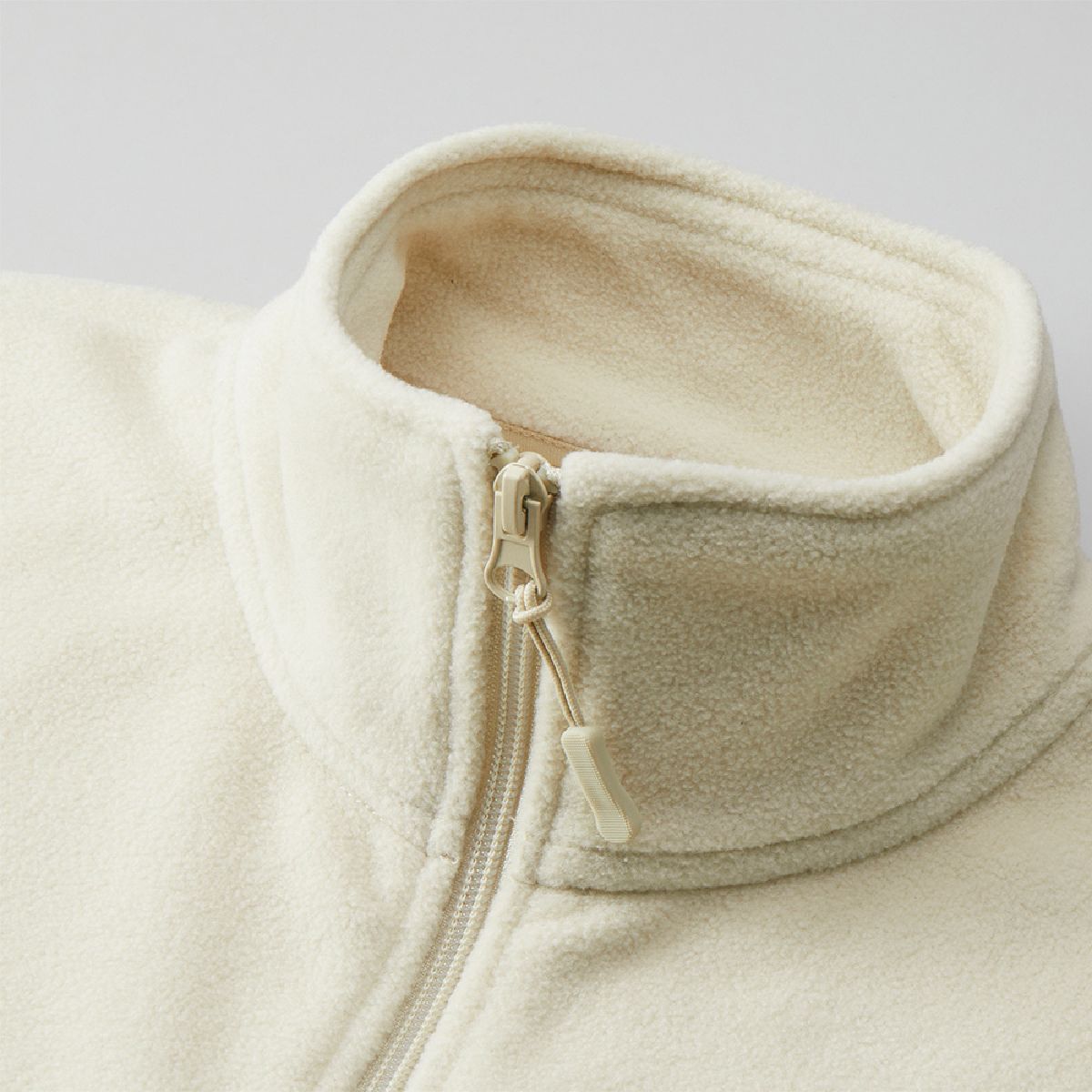 The collar is a stand color, and the coil fastener has a zipper tab