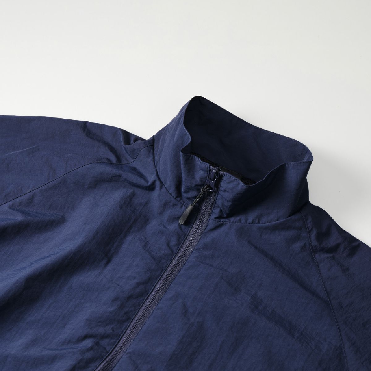 The collar is a stand color reminiscent of military training wear