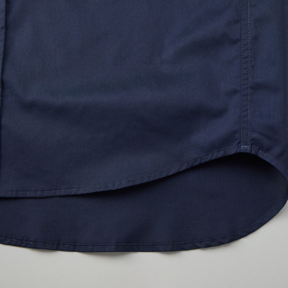 The hem has a rounded tail design.