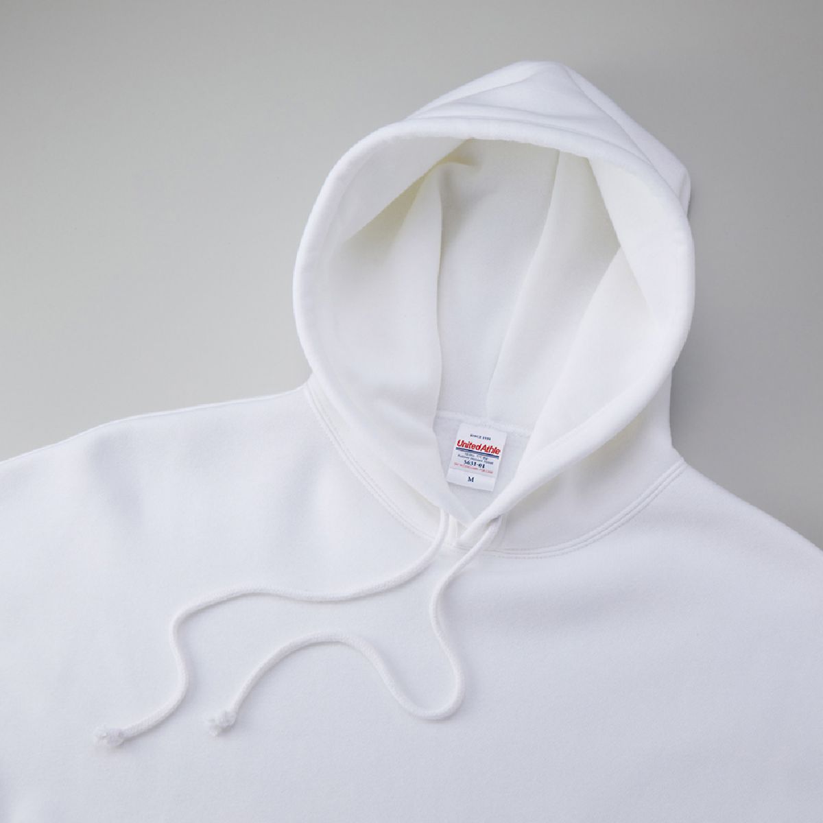 It features a distinctive, oversized double hood, and the hood drawstring is the same color as the body.